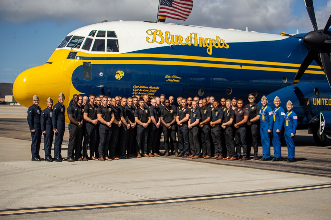 Marines with the Silent Drill Platoon stand for a photo with the Blue Angels’ “Fat Albert” C-130J Super Hercules aircraft at San Diego, Calif., March 3, 2022. The Silent Drill Platoon and the Official U.S. Marine Corps Color Guard had the privilege to fly aboard “Fat Albert” to San Diego.