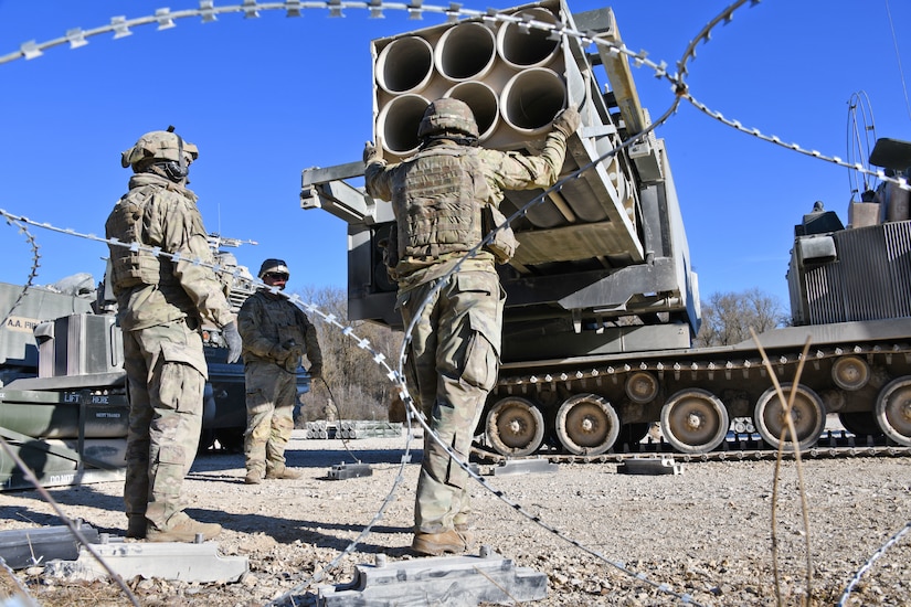 Soldiers load M270 Multiple Launch Rocket Systems for a live fire exercise.