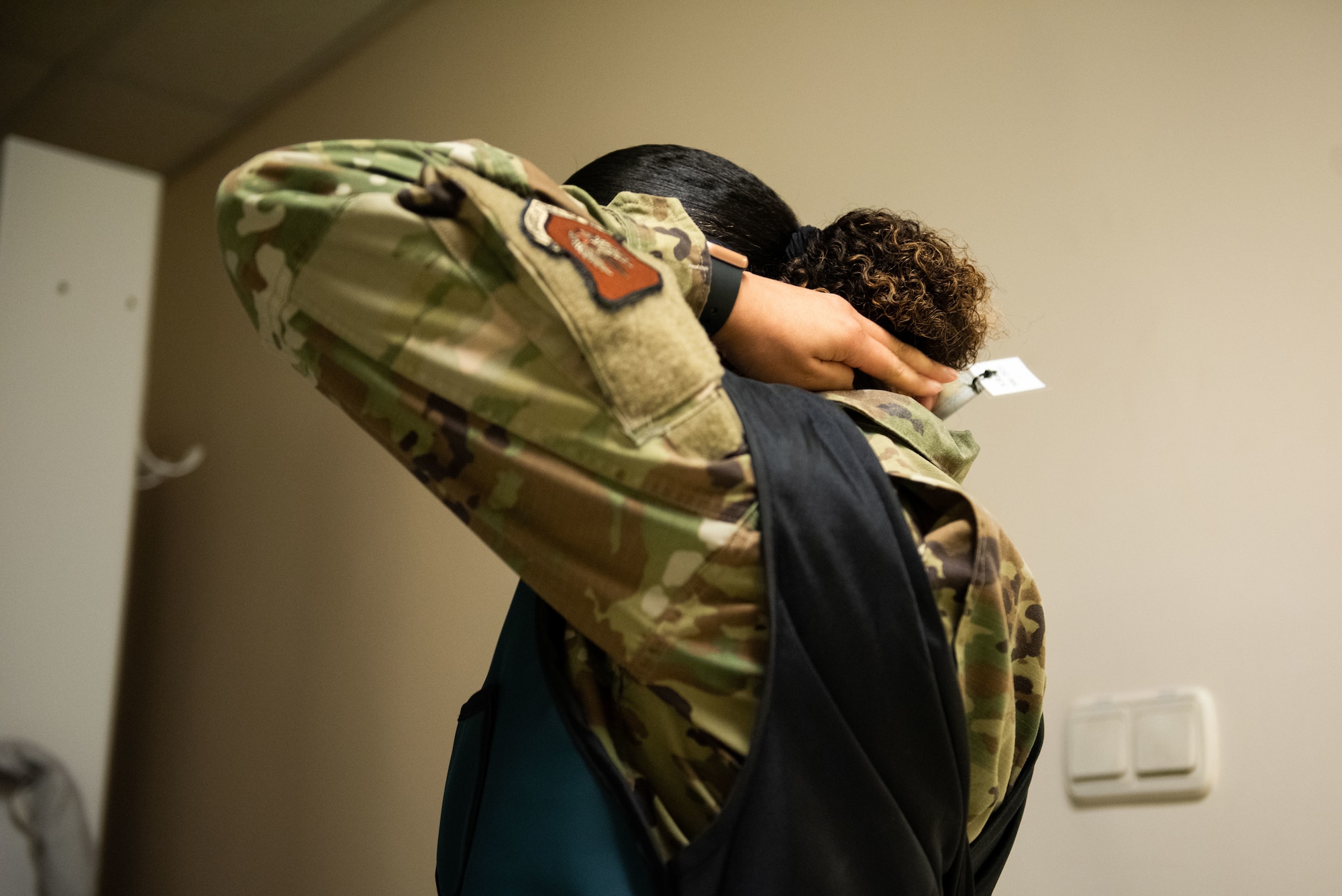 Staff Sgt. Gloria Garcia, an ultrasound technician assigned to the 39th Medical Group, puts on a lead radiology shield at Incirlik Air Base, Turkey, March 14, 2022. Radiology uses X-rays to photograph human anatomy to assist doctors in identifying potential disease and injury to continue caring for patients. (U.S. Air Force photo by Airman 1st Class Brandt Self)