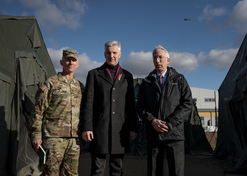 Artis Pabriks, Latvia Minister of Defence (center), John L. Carwile (right), U.S. Ambassador to the Republic of Latvia and U.S. Army Major General Douglas A. Sims II (left), Commanding General, 1st Infantry Division and Fort Riley, visit Soldiers from 1-3rd Attack Battalion, 12th Combat Aviation Brigade at Lielvārde Air Base, March 4, 2022. Enhancing our interoperability with our NATO allies and partners strengthens the regional relationships that we have developed. 12 CAB is the only enduring aviation brigade present throughout Europe that enables us to deter and defend against threats from any direction. (U.S. Army photo by Staff Sgt. Thomas Mort)
