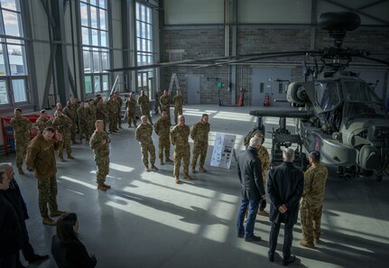 Arturs Krišjānis Kariņš, Prime Minister of Latvia, Artis Pabriks, Latvia Minister of Defence and U.S. Army Major General Douglas A. Sims II, Commanding General, 1st Infantry Division and Fort Riley, meet with Soldiers from 1-3rd Attack Battalion, 12th Combat Aviation Brigade at Lielvārde Air Base, March 4, 2022. Enhancing our interoperability with our NATO allies and partners strengthens the regional relationships that we have developed. 12 CAB is the only enduring aviation brigade present throughout Europe that enables us to deter and defend against threats from any direction. (U.S. Army photo by Staff Sgt. Thomas Mort)