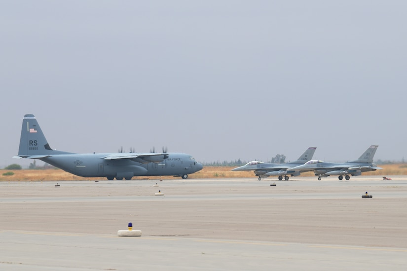 Three aircraft sit on an airfield.