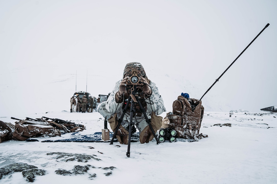 A U.S. Marine attached to 3rd Battalion, 6th Marine Regiment, 2nd Marine Division, scans for targets for a Fire Support Coordination exercise prior to Exercise Cold Response 22 in Setermoen, Norway, March 7, 2022. Exercise Cold Response 22 is a biennial Norwegian national readiness and defense exercise that takes place across Norway, with participation from each of its military services, including 26 North Atlantic Treaty Organization allied nations and regional partners.