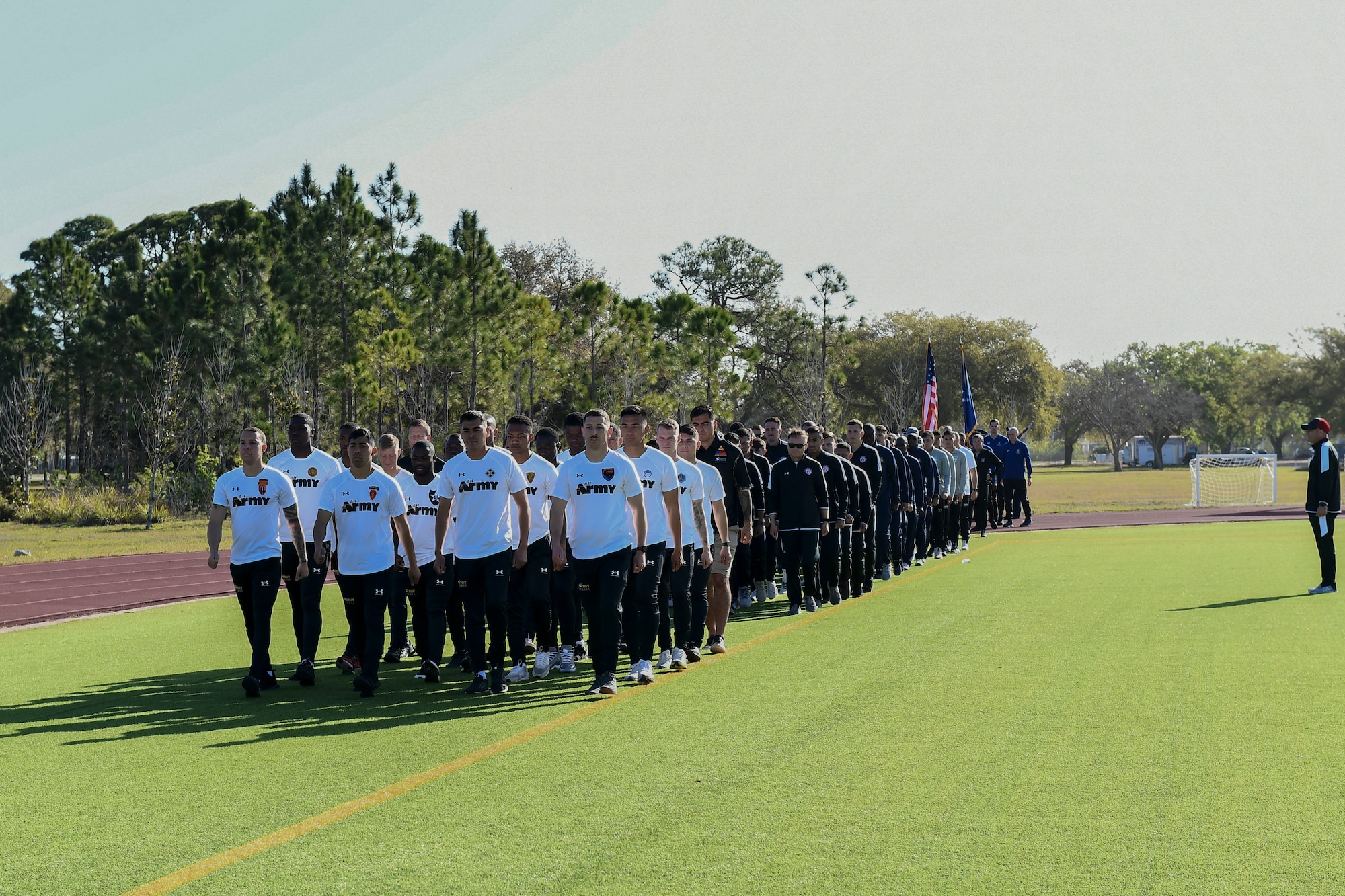 U.S. service members march together during the opening ceremony of the Armed Forces Men’s Soccer Championship at MacDill Air Force Base, Florida, March 6, 2022.