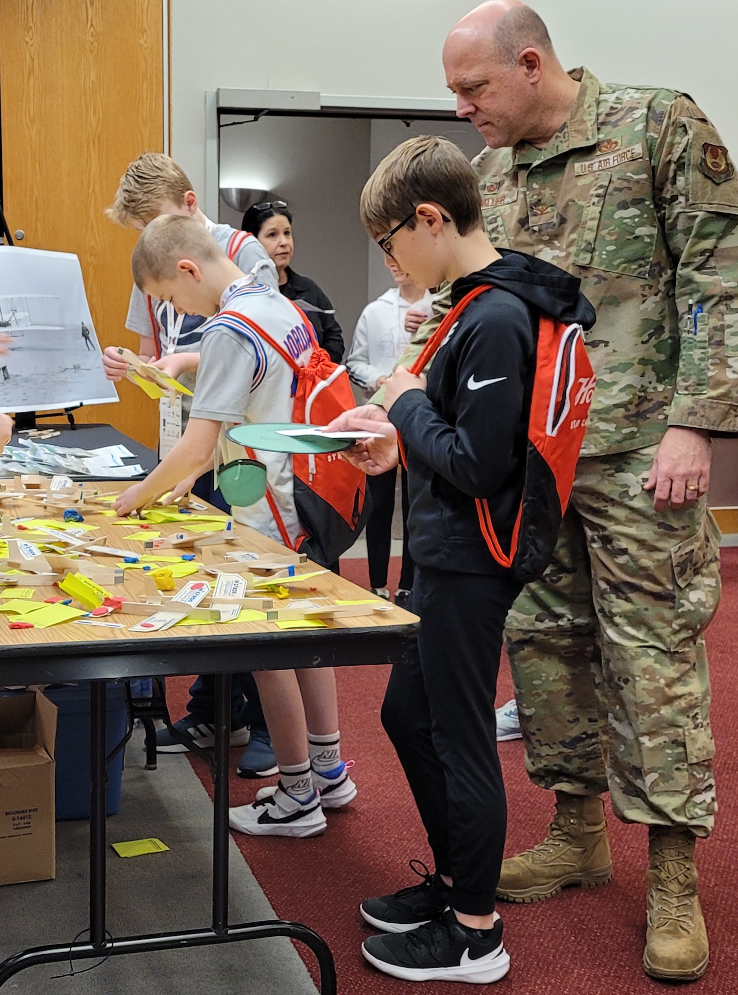Col. Patrick Miller, 88th Air Base Wing commander, watches his son Justin build a model plane at the Wright-Patterson Air Force Base Educational Outreach booth during The Big Hoopla STEM Challenge March 13 at the Dayton Convention Center. (U.S. Air Force photo/Gina Marie Giardina)