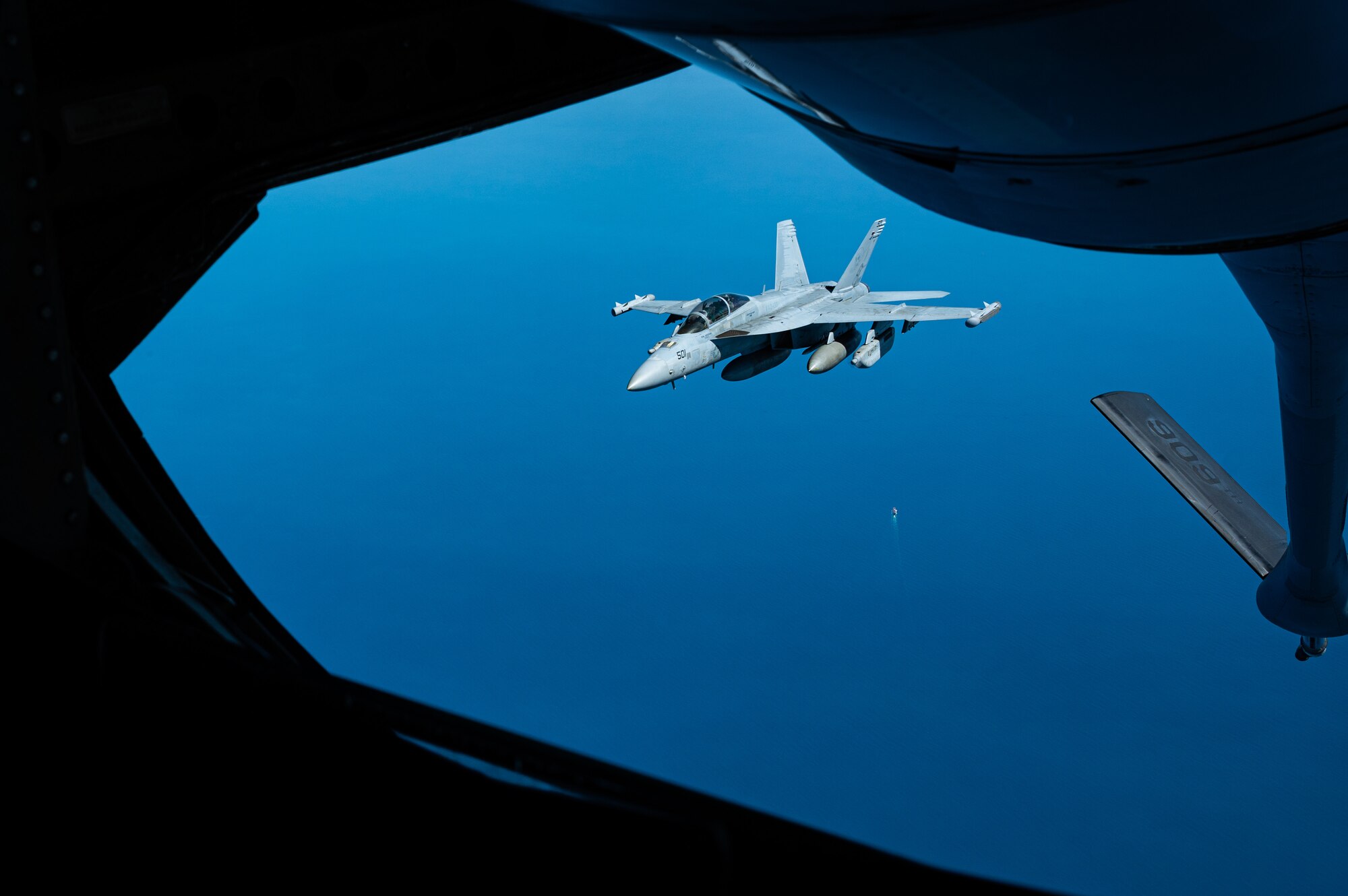 An EA-18G Growler from Electronic Attack Squadron (VAQ) 133 departs after receiving fuel from a KC-135 Stratotanker, 909th Aerial Refueling Squadron, Kadena Air Base, Japan, over the Pacific Ocean March 15, 2022. The fighter aircraft launched from the flight deck of the Nimitz-class aircraft carrier USS Abraham Lincoln (CVN 72) to conduct a joint long-range air demonstration in the Yellow Sea, March 15. Versatile air, sea, land, space and cyberspace mission platforms give the U.S., its allies and partners, the ability to operate in today’s constantly changing threat environments. U.S. Indo-Pacific Command stands ready to respond to any contingency, anywhere in the theater. (U.S. Air Force photo by Senior Airman Stephen Pulter)