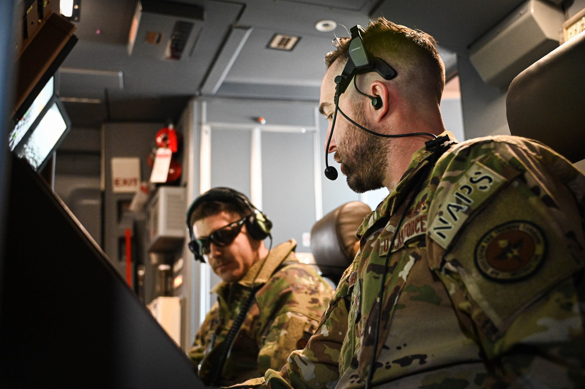 U.S. Air Force Tech. Sgt. Ian Sweaney (right), 56th Air Refueling Squadron evaluator boom operator, explains the boom operator station on a KC-46 Pegasus to Tech. Sgt. Joshua, 432nd Air Expeditionary Wing evaluator sensor operator, March 10, 2022. Seven sensor operators visited Altus Air Force Base, Oklahoma, to learn more about boom operators and the KC-46. (U.S. Air Force photo by Senior Airman Kayla Christenson)