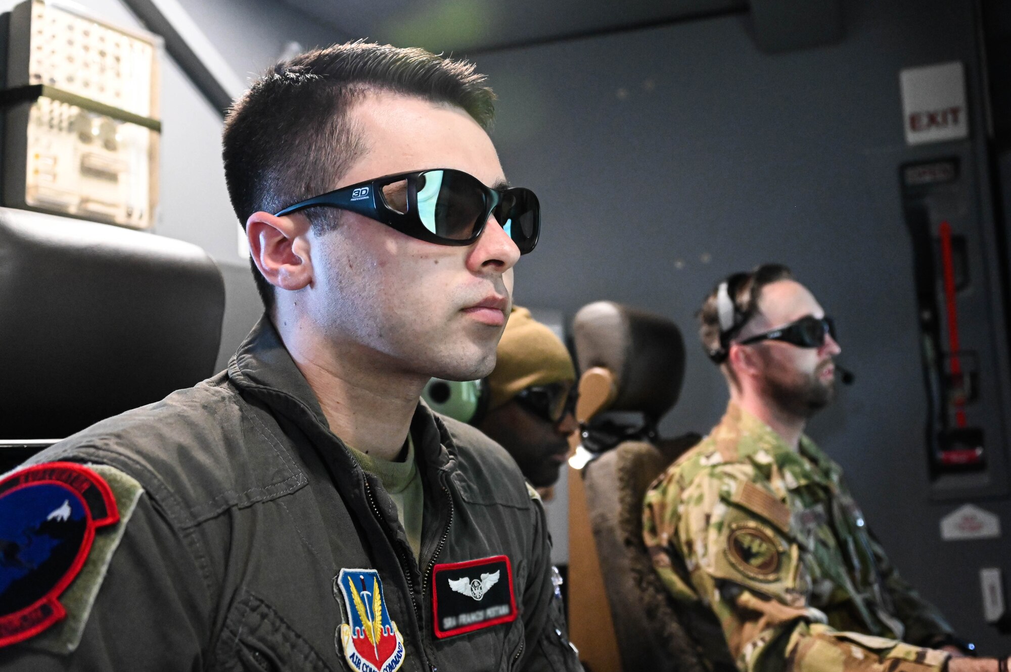 From left, U.S. Air Force Senior Airman Francis, 432nd Air Expeditionary Wing (AEW) evaluator sensor operator, Tech. Sgt. Marcus, 432nd AEW evaluator sensor operator, watch Tech. Sgt. Ian Sweaney, 56th Air Refueling Squadron evaluator boom operator, refuel a KC-135 Stratotanker, March 10, 2022. Sensor operators remotely control aircraft to gather intelligence and surveillance. (U.S. Air Force photo by Senior Airman Kayla Christenson)