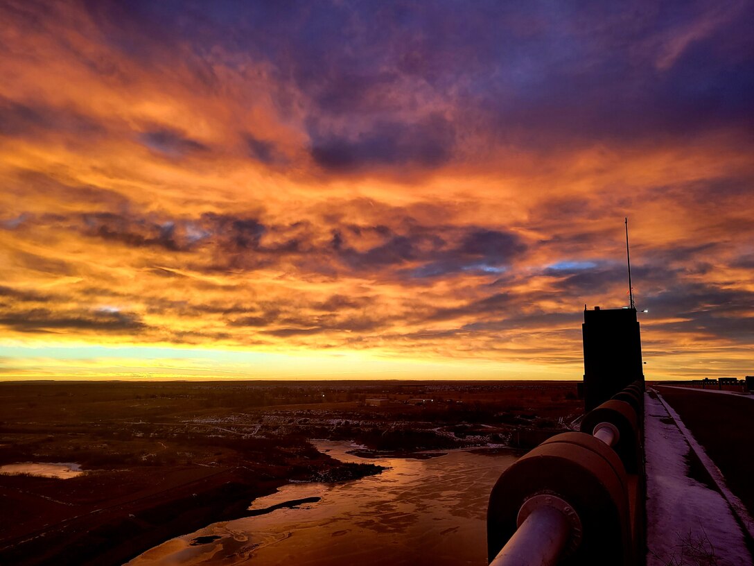 JOHN MARTIN RESERVOIR, Colo. -- The sun vibrantly rises over John Martin Dam on a chilly winter morning, Jan. 8, 2022. Photo by Holly Garnett, park ranger, John Martin Reservoir.