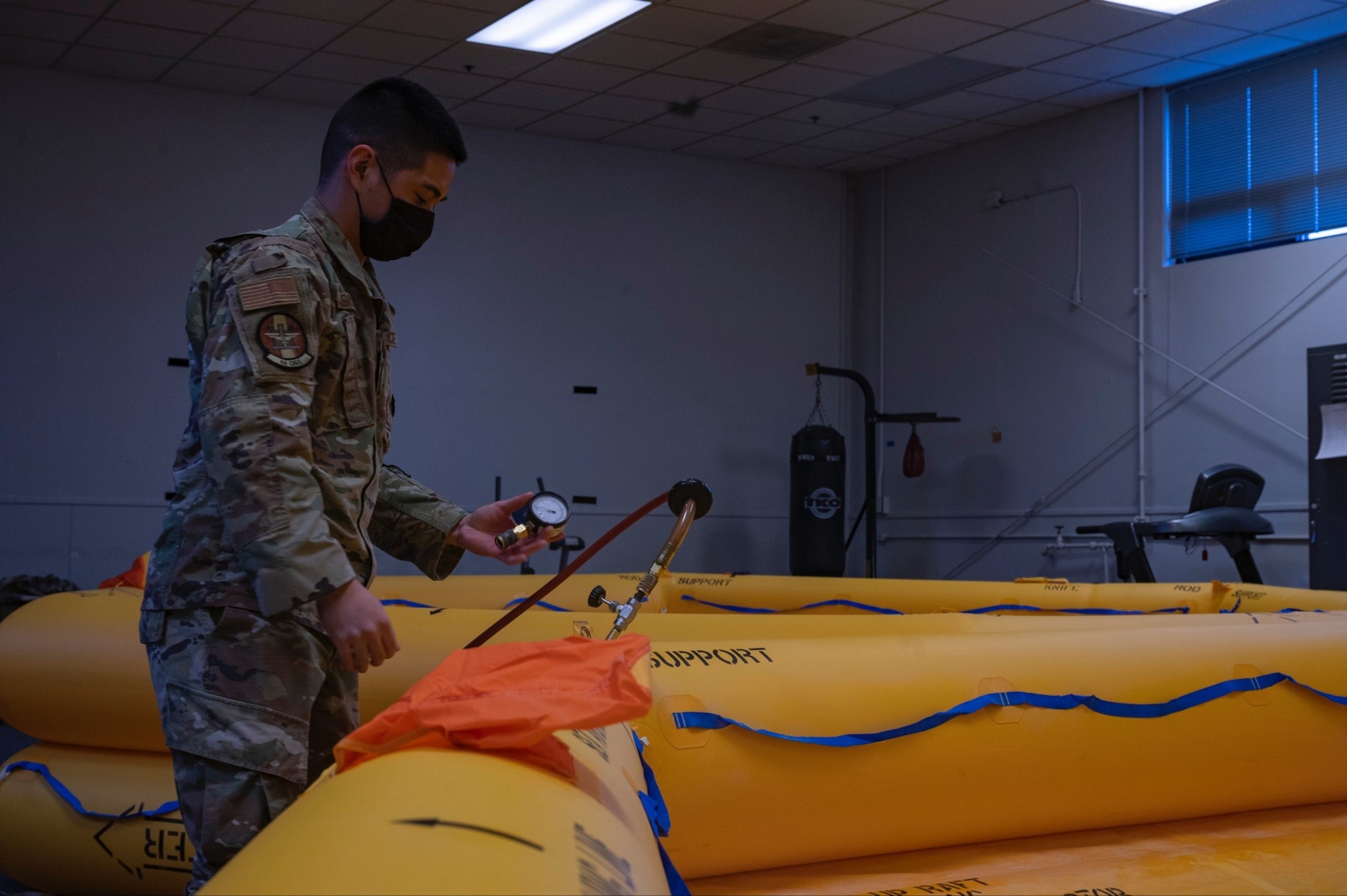 U.S. Air Force Airman 1st Class Dwaine Asis, 62nd Operations Support Squadron, aircrew flight equipment apprentice, conducts a leak check inspections on life rafts at Joint Base Lewis-McChord, Wash., Feb. 19, 2022. These Airmen manage, perform inspections, maintenance, and adjustments of assigned aircrew flight equipment, aircrew chemical defense equipment, night vision goggles, and aircrew laser eye protection. (U.S. Air Force photo by Airman 1st Class Charles Casner)