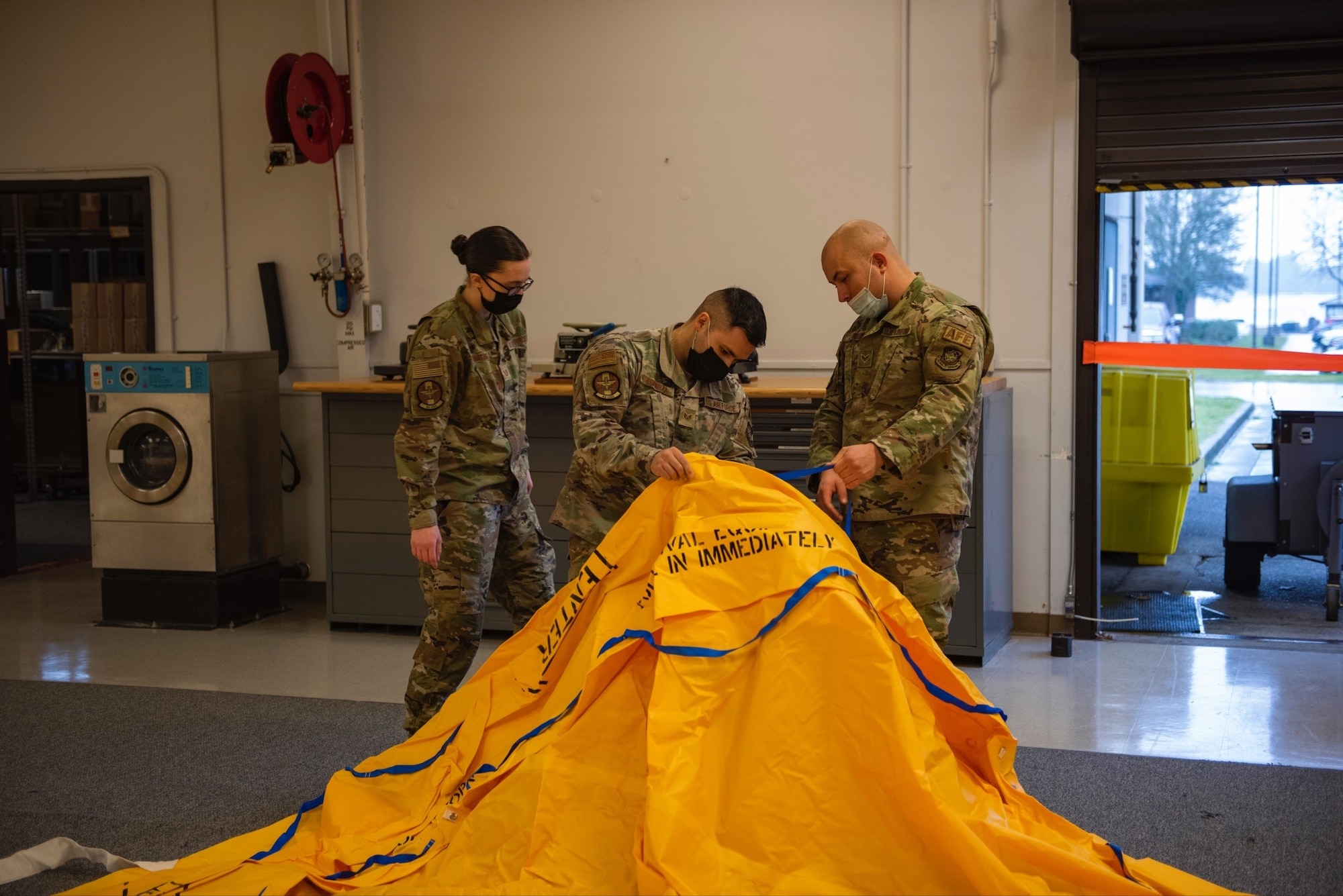 U.S. Air Force Airmen from the 62nd Operations Group aircrew flight equipment section, conduct life raft inspections at Joint Base Lewis-McChord, Wash., Feb. 19, 2022. The AFE members perform inspections, maintenance, and adjustments of assigned aircrew flight equipment, aircrew chemical defense equipment, night vision goggles, and aircrew laser eye protection. (U.S. Air Force photo by Tech. Sgt. Benjamin Sutton)