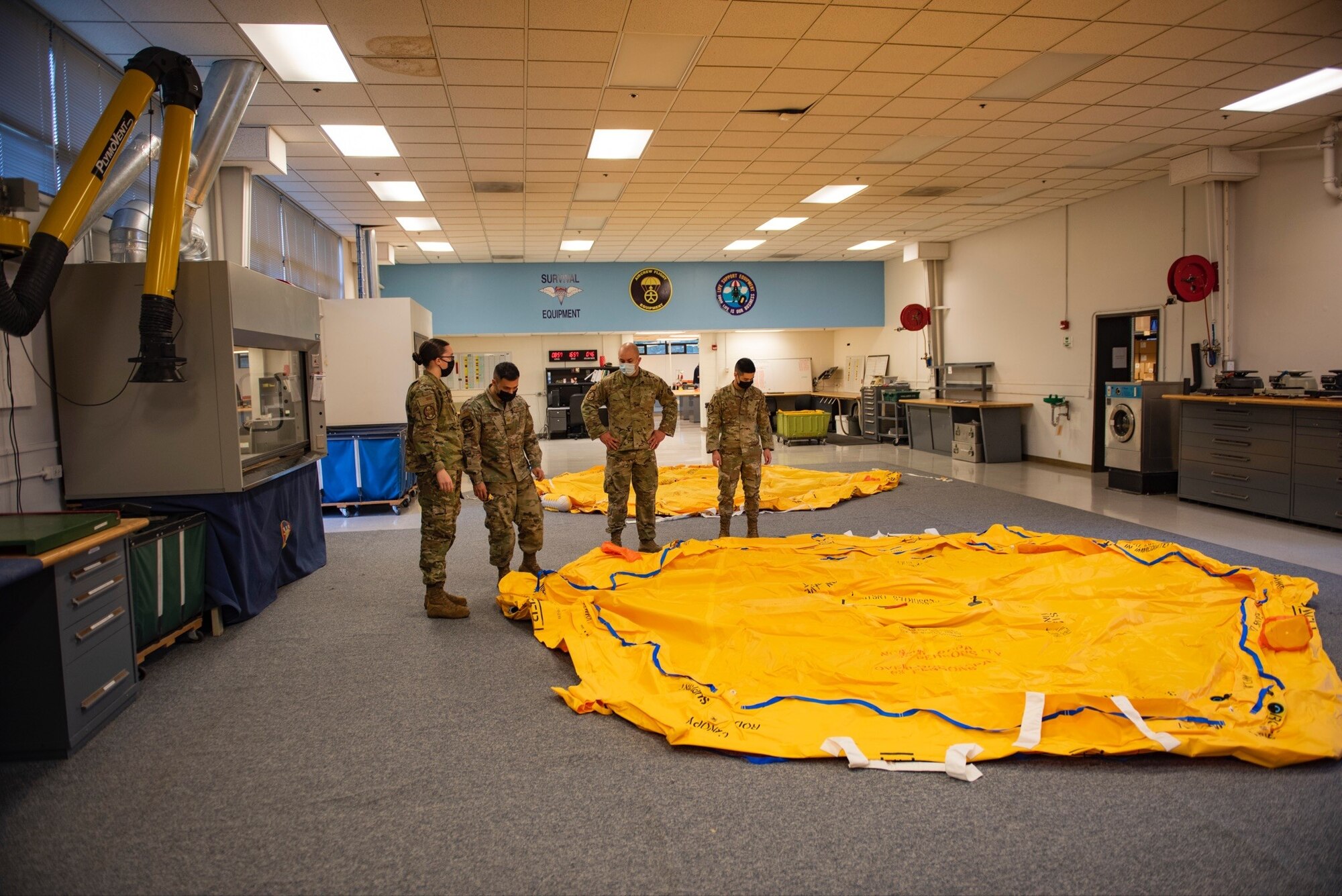 U.S. Air Force Airmen from the 62nd Operations Group aircrew flight equipment section, conduct life raft inspections at Joint Base Lewis-McChord, Wash., Feb. 19, 2022. The AFE members also perform inspections, maintenance, and adjustments of assigned aircrew flight equipment, aircrew chemical defense equipment, night vision goggles, and aircrew laser eye protection. (U.S. Air Force photo by Tech. Sgt. Benjamin Sutton)