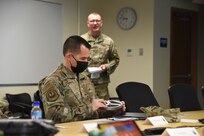Chief Master Sgt. Frank Harpster, AFMC/AFSC Senior Enlisted Leader examines an aircraft part created by the additive manufacturing process.