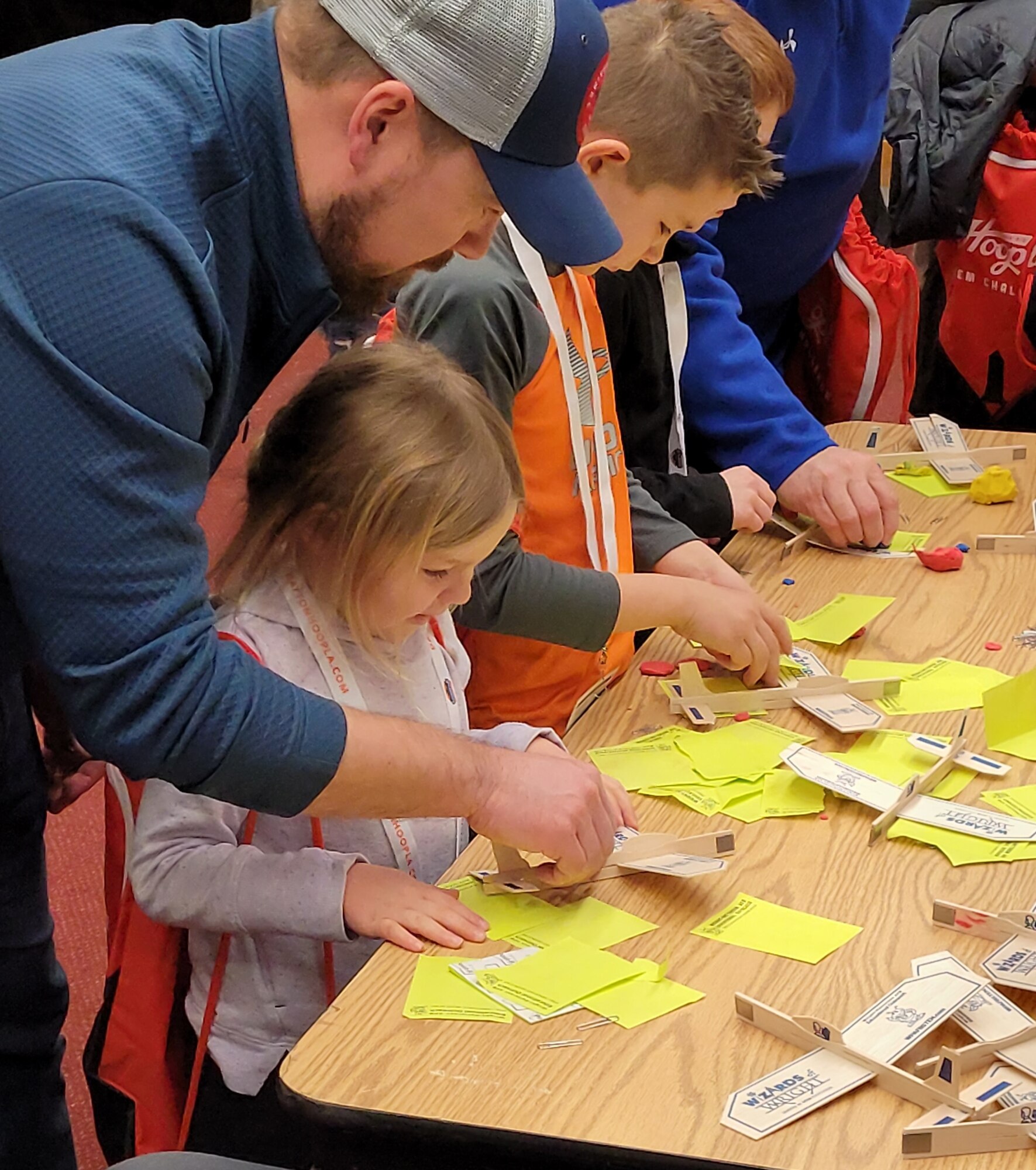 Visitors of the Wright-Patterson Air Force Base Educational Outreach booth build model airplanes during The Big Hoopla STEM Challenge March 13 at the Dayton Convention Center. (U.S. Air Force photo/ Gina Marie Giardina)