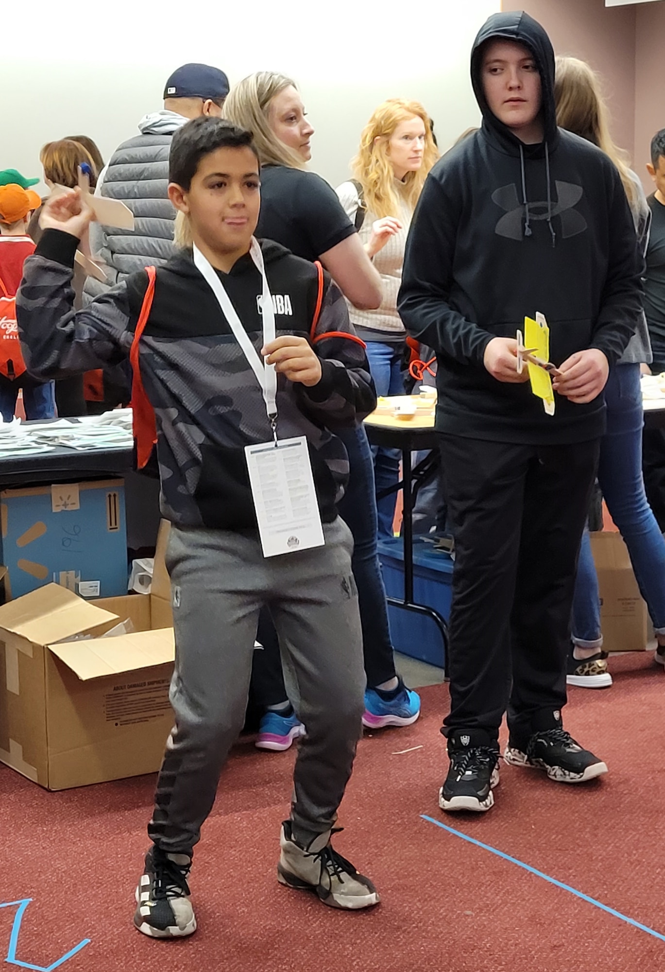 A student tests his model plane in the Wright-Patterson Air Force Base Educational Outreach booth during The Big Hoopla STEM Challenge March 13 at the Dayton Convention Center. (U.S. Air Force photo/Gina Marie Giardina)