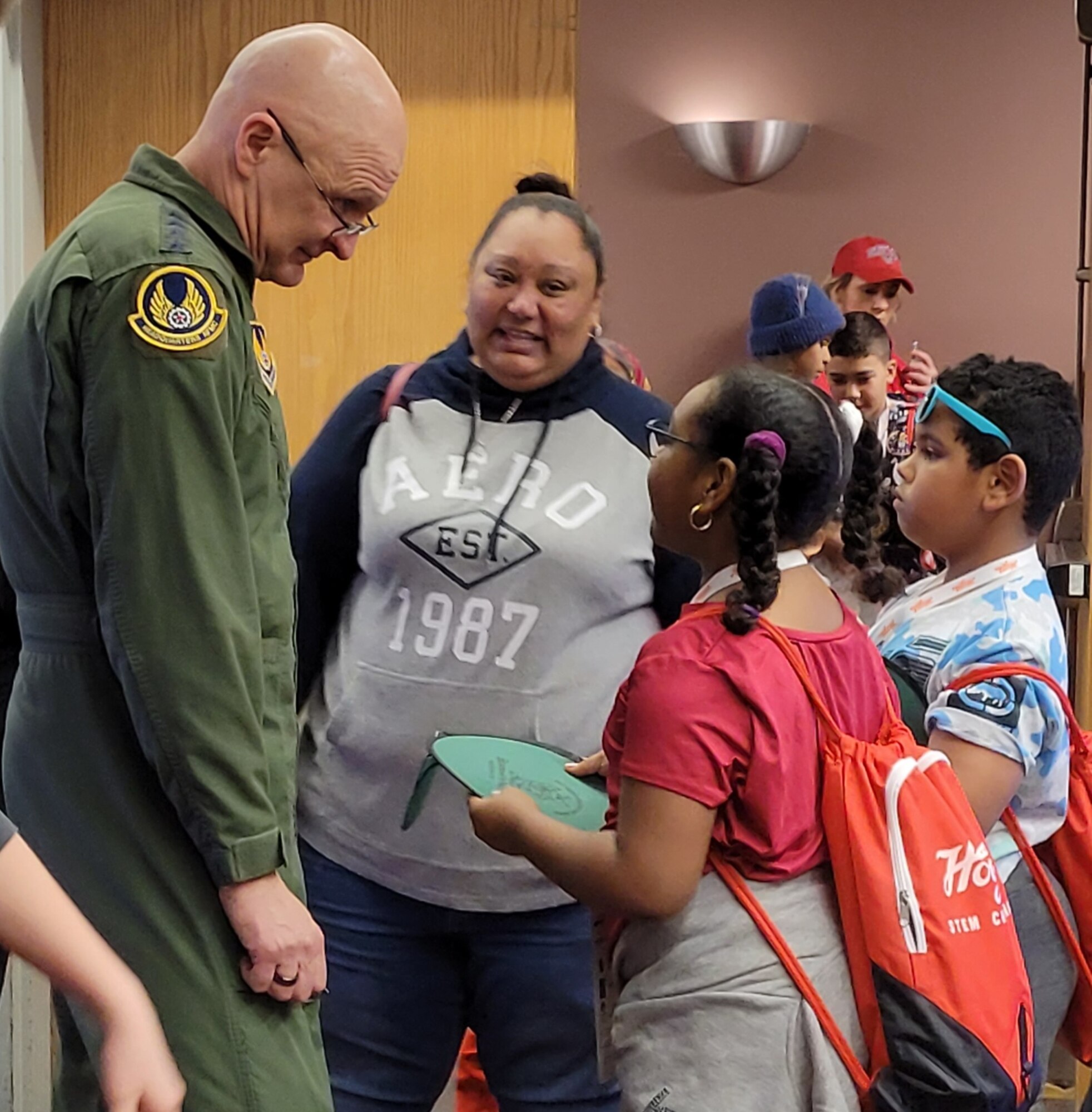 Gen. Arnold W. Bunch, Jr., Air Force Materiel Command commander, speaks with a family that stopped by the Wright-Patterson Air Force Base Educational Outreach Educational Outreach booth during The Big Hoopla STEM Challenge March 13 at the Dayton Convention Center. (U.S. Air Force photo/Gina Marie Giardina)
