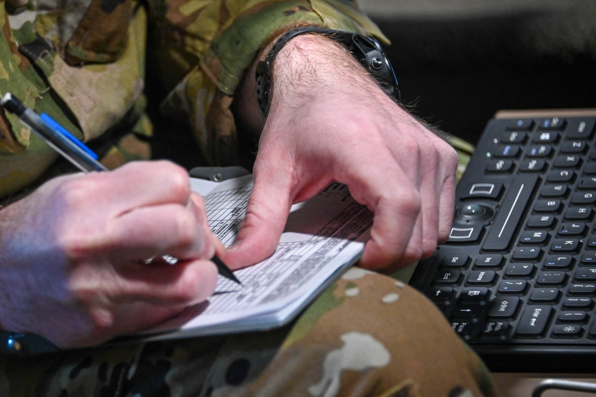 U.S. Air Force Tech. Sgt. Ian Sweaney, 56th Air Refueling Squadron evaluator boom operator, writes information down while checking the boom operator station on a KC-46 Pegasus before taking off at Altus Air Force Base, Oklahoma, March 10, 2022. Evaluator boom operators, one of the highest positions in instructor training, train students and instructors, and serve as the final approver on check rides. (U.S. Air Force photo by Senior Airman Kayla Christenson)