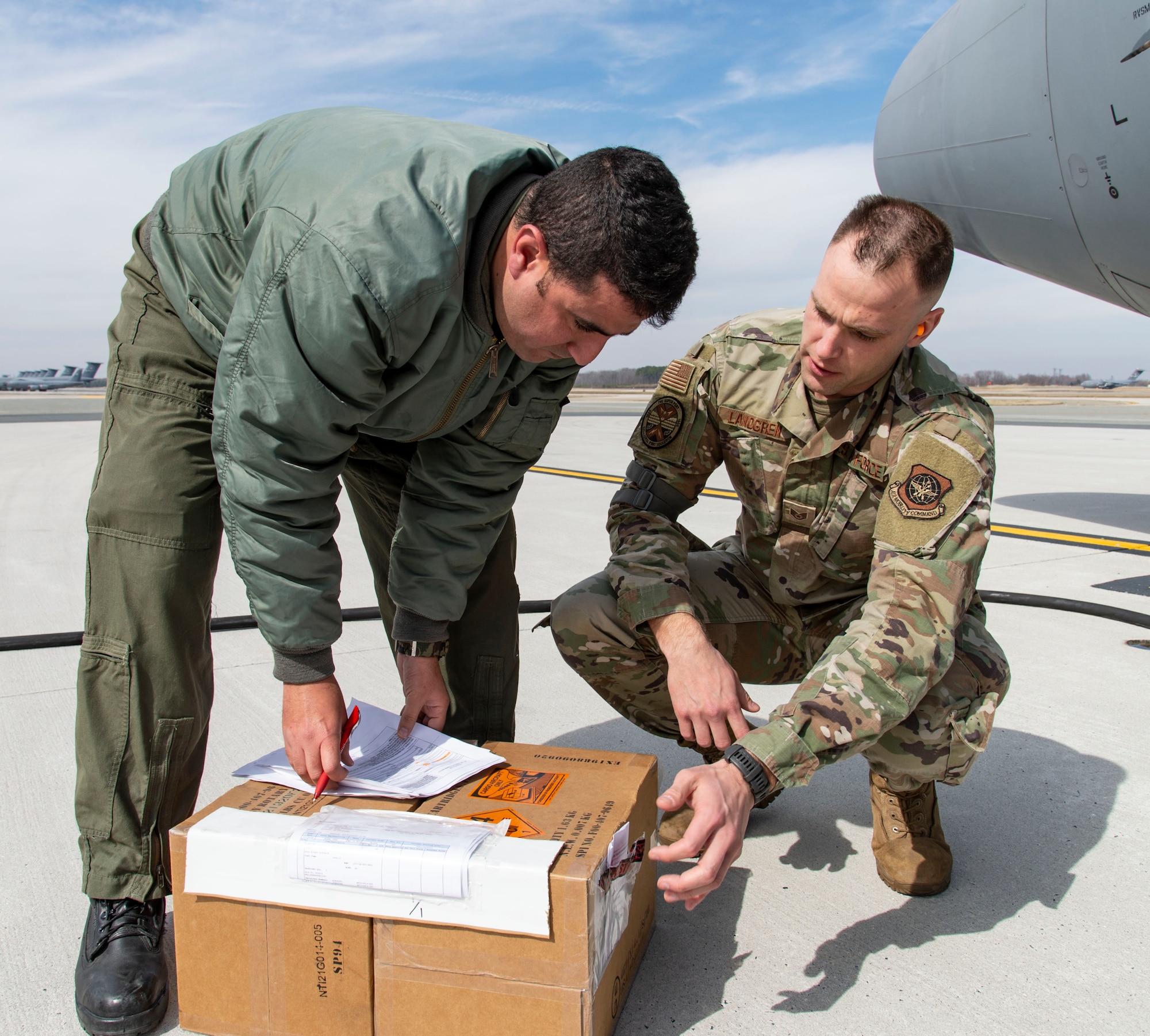 Staff Sgt. Steven Landgren, 436th Aerial Port Squadron special handling supervisor, delivers foreign military sales cargo and reviews shipping documents with a Tunisian air force C-130J Super Hercules aircrew member at Dover Air Force Base, Delaware, March 10, 2022. The U.S. and Tunisia have enjoyed strong diplomatic relations for over 200 years, beginning when the two countries signed the Treaty of Peace and Friendship in 1797. Due to its strategic geographic location, Dover AFB supports approximately $3.5 billion worth of FMS operations annually. (U.S. Air Force photo by Roland Balik)
