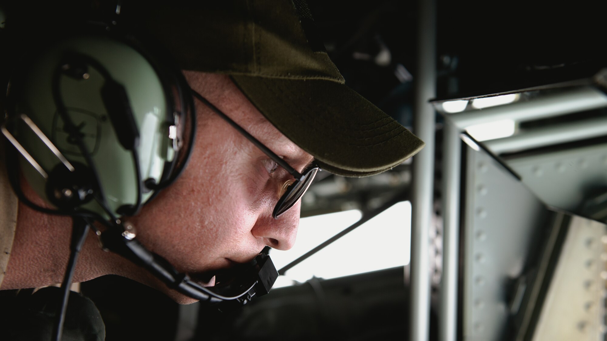 Aerial refueling specialist operates KC-135 refueling boom.