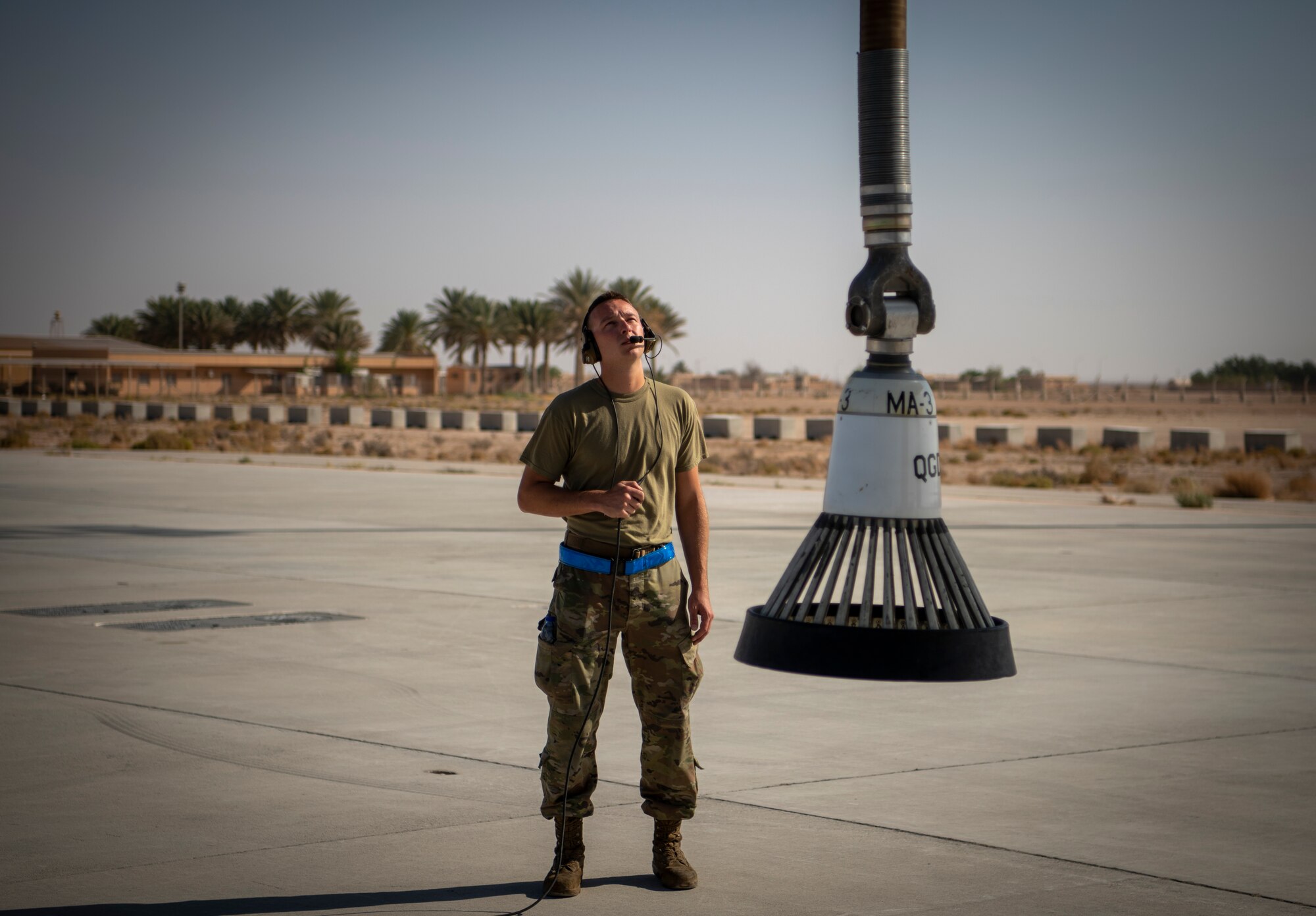 Airman inspects KC-135 fuel hose.