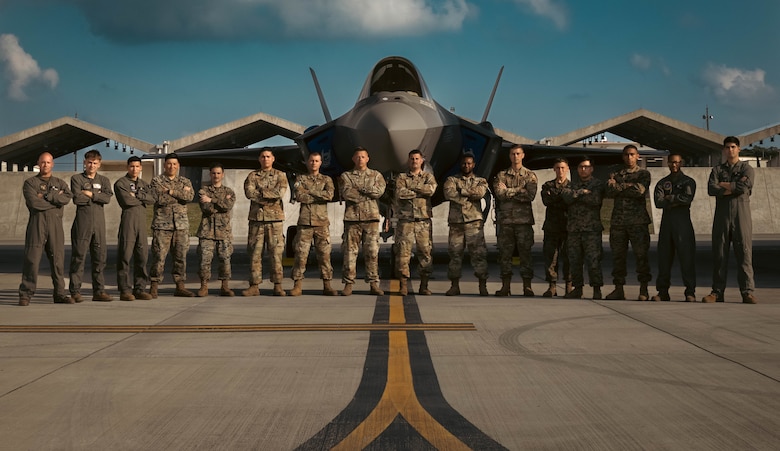 U.S. Marines, with Marine Corps Installations Pacific, and Airmen with the 355th Expeditionary Fighter Squadron pose for a photo during a hot-pit refueling training no Kadena Air Base, March 9, 2022. The training refined and enhanced the multiple aircraft platform skills of participating Marines, focusing on hot-pit refueling the F-35A Lightning II with limited time, simulating an operational environment. During hot-pit refueling, the aircraft maintains a running engine, which decreases the response time in an operational environment. (U.S. Marine Corps photo by Lance Cpl. Jonathan Beauchamp)
