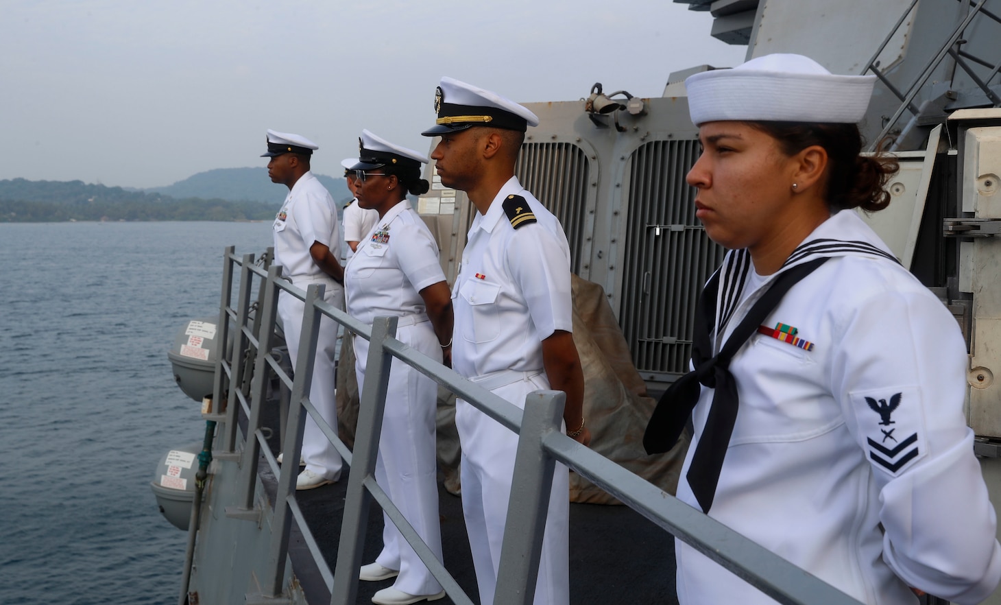 TRINCOMALEE, SRI LANKA (March 13, 2022) Sailors man the rails on the foc’sle of the Arleigh Burke-class guided-missile destroyer USS Fitzgerald (DDG 62) while the Sri Lankan Navy band plays on the pier. Fitzgerald is on a scheduled deployment in the U.S. 7th Fleet area of operations to enhance interoperability with alliances and partnerships while serving as a ready-response force in support of a free and open Indo-Pacific region. (U.S. Navy photo by Mass Communication Specialist 3rd Class Catie Coyle)