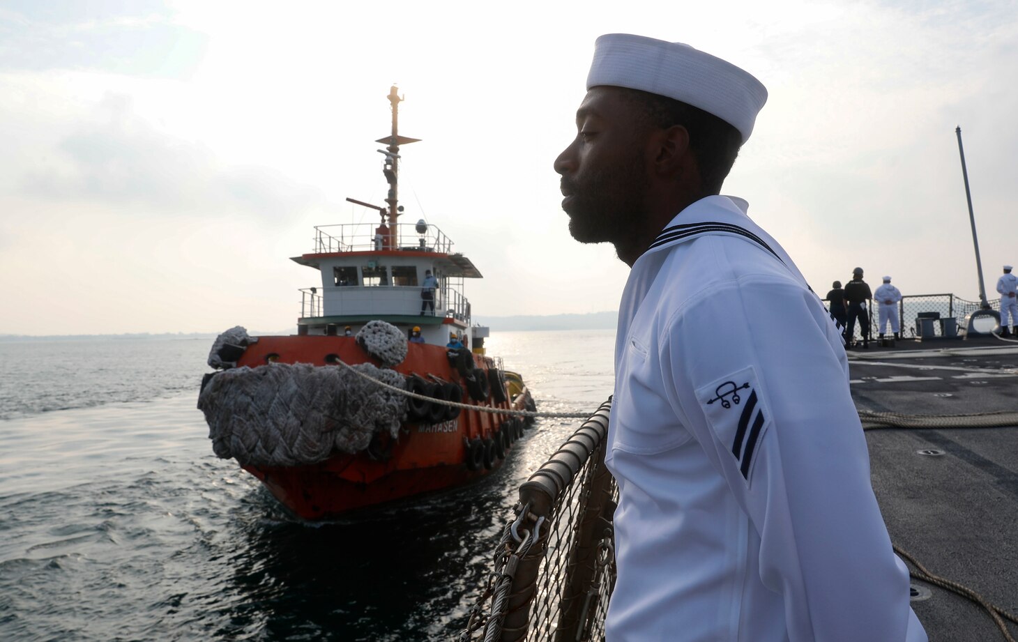 TRINCOMALEE, SRI LANKA (March 13, 2022) Sailors man the rails on the foc’sle of the Arleigh Burke-class guided-missile destroyer USS Fitzgerald (DDG 62) while the Sri Lankan Navy band plays on the pier. Fitzgerald is on a scheduled deployment in the U.S. 7th Fleet area of operations to enhance interoperability with alliances and partnerships while serving as a ready-response force in support of a free and open Indo-Pacific region. (U.S. Navy photo by Mass Communication Specialist 3rd Class Catie Coyle)