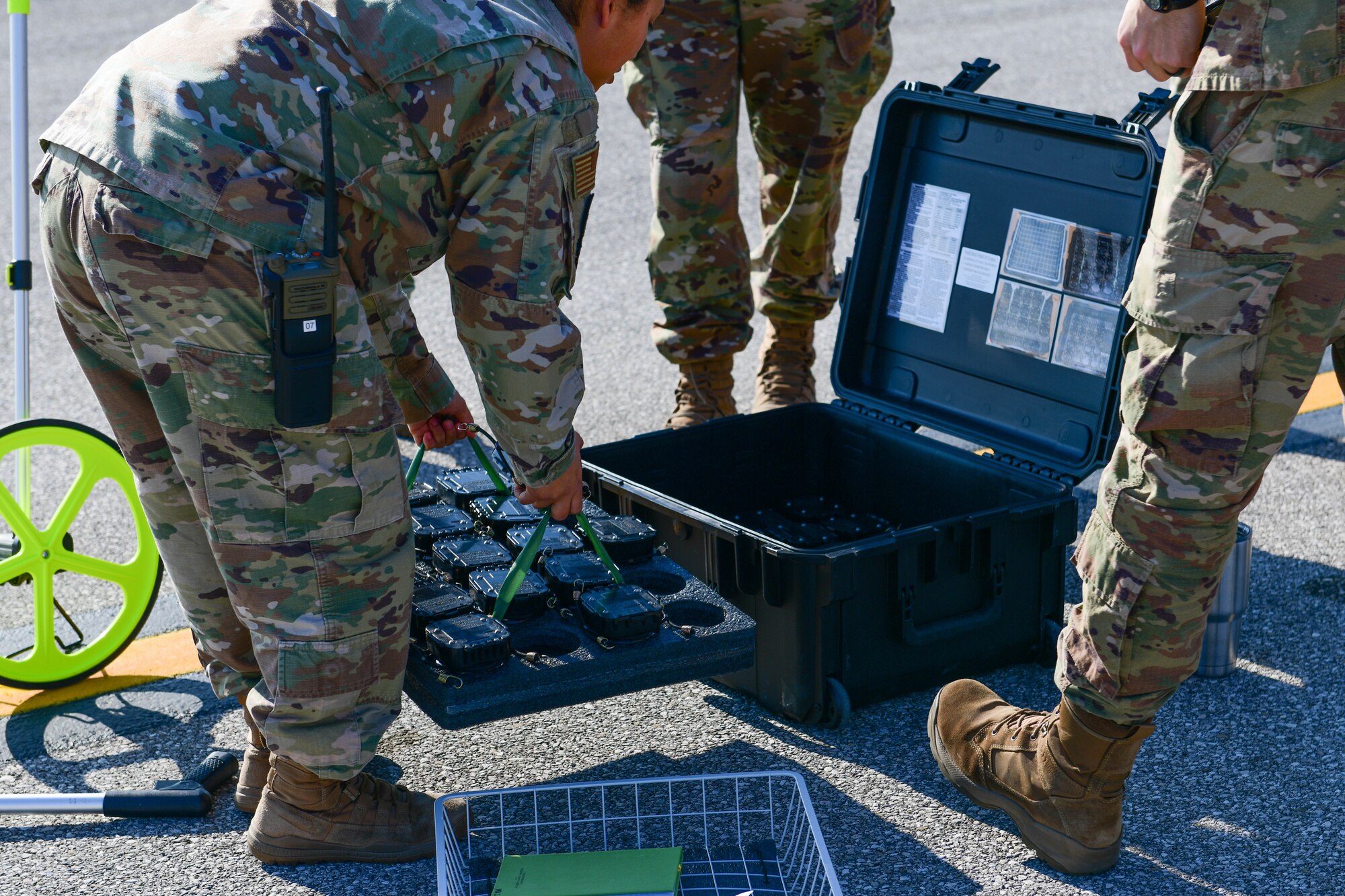 U.S. Air Force Airmen assigned to the 31st Operations Support Squadron take lights out of a kit during a training session at Aviano Air Base, Italy, March 10, 2022. U.S. Air Force Airmen assigned to the 31st OSS Air Traffic Control Tower and Airfield Management section trained with and tested Phantom AZL-15 lighting kits. The Phantom AZL-15 lighting kit contains approximately 35 LED lamps that are powered with batteries and can be turned on anytime or set up with remotes. (U.S. Air Force photo by Senior Airman Brooke Moeder)