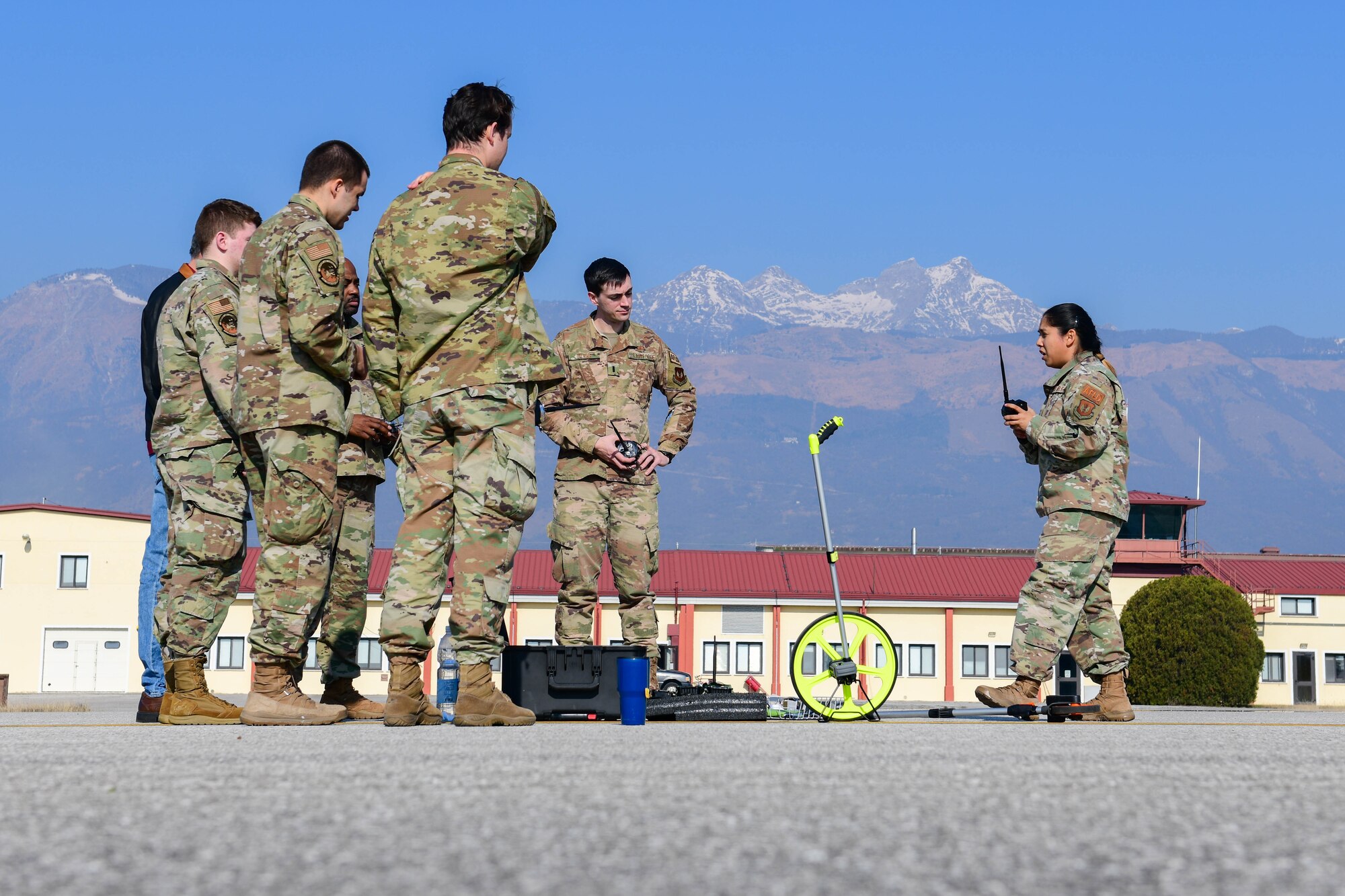 Tech. Sgt. Phonkamon Gehres, 31st Operations Support Squadron wing airfield driving program manager, briefs airfield management contingency response procedures to 31st OSS members at Aviano Air Base, Italy, March 10, 2022. The members used a Phantom AZL-15 lighting kit to simulate landing zones for a variety of aircraft including, C-17 Globemasters and C-130 Hercules. The Phantom AZL-15 lighting kit contains approximately 35 LED lamps that are powered with batteries and can be turned on anytime or set up with remotes. (U.S. Air Force photo by Senior Airman Brooke Moeder)
