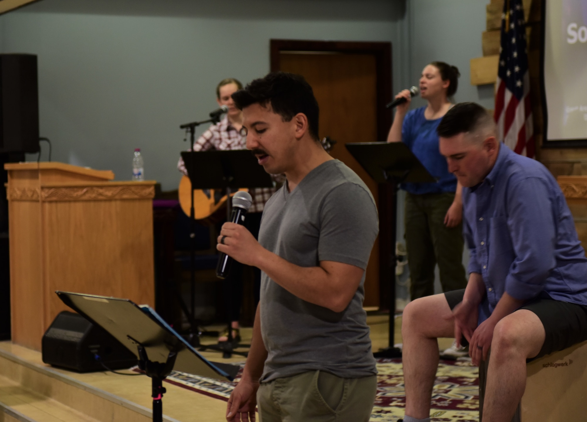 photo of a military chapel music group singing and playing music during religious service