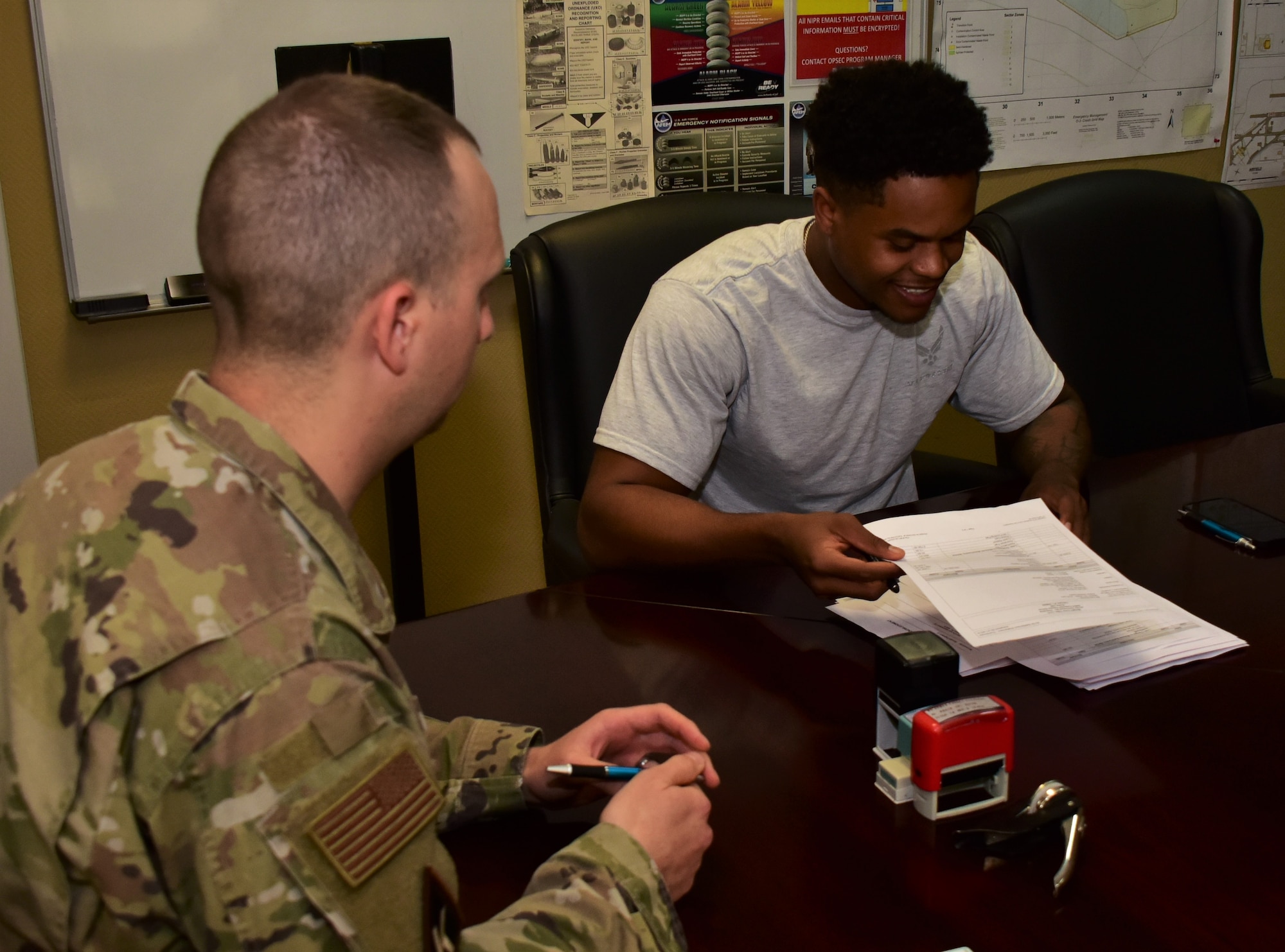 photo of an Airman reading over a legal document at a legal office