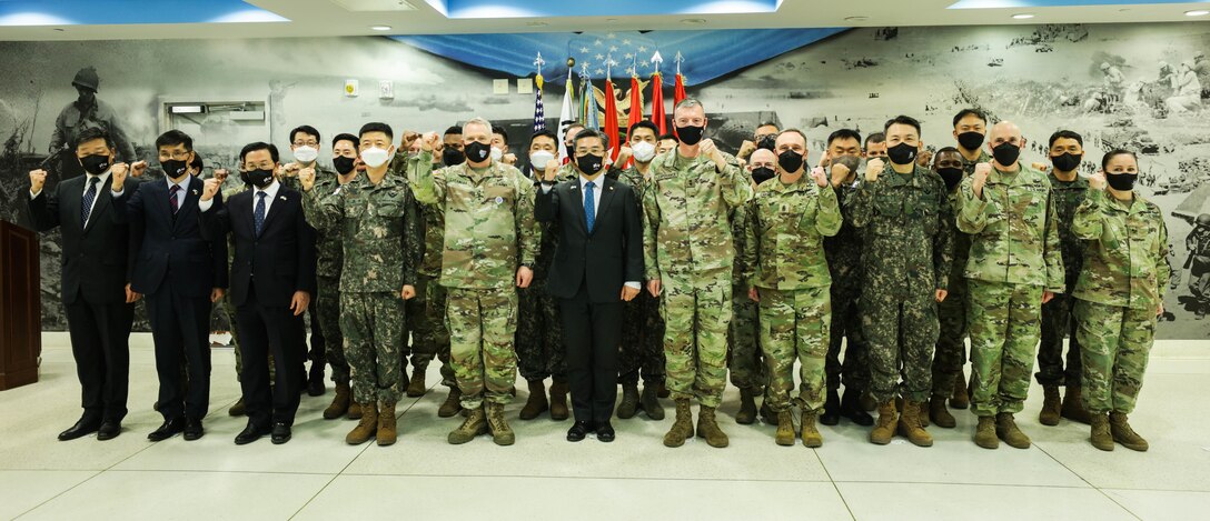 Members of Republic of Korea Ministry of Defense, United Nations Command, Combined Forces Command, U.S. Forces Korea, and 2nd Infantry Division/ROK-U.S. Combined Division stand together at 2ID Headquarters’ Hall of Heroes, Republic of Korea, March 16, 2022.