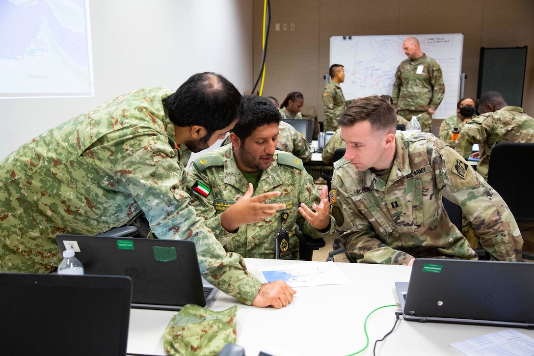 Capt. Bryan Alger, with the U.S. Army Corps of Engineers, right, engages in a consequence management discussion with counterparts from Gulf Cooperation Council (GCC) partner nations during exercise Eagle Resolve 22, at Fort Carson, Colorado, March 12, 2022. Alger’s team focused on protecting critical infrastructure from missile attacks. During Eagle Resolve 22 the U.S. and GCC nations work together through simulated scenarios to respond as a Combined Joint Task Force (CJTF) headquarters staff, while strengthening relationships and promoting enduring partnerships. (U.S. Army photo by Spc. Robert Vicens)