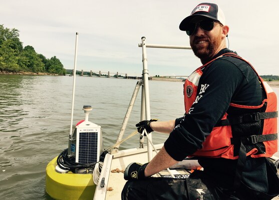 While assigned to the Huntington District, Payne deploys a buoy with water quality monitoring sensors on it to monitor oxygen levels on the Ohio River while USACE was dredging below the Robert C. Byrd lock/dam. (USACE Photo by Aric Payne)