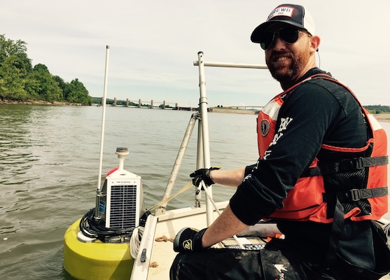 While assigned to the Huntington District, Payne deploys a buoy with water quality monitoring sensors on it to monitor oxygen levels on the Ohio River while USACE was dredging below the Robert C. Byrd lock/dam. (USACE Photo by Aric Payne)