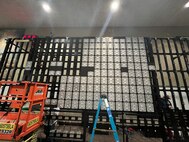 Photo of Tobyhanna employees installing a high-tech LED micro-tile video wall and all video processing equipment