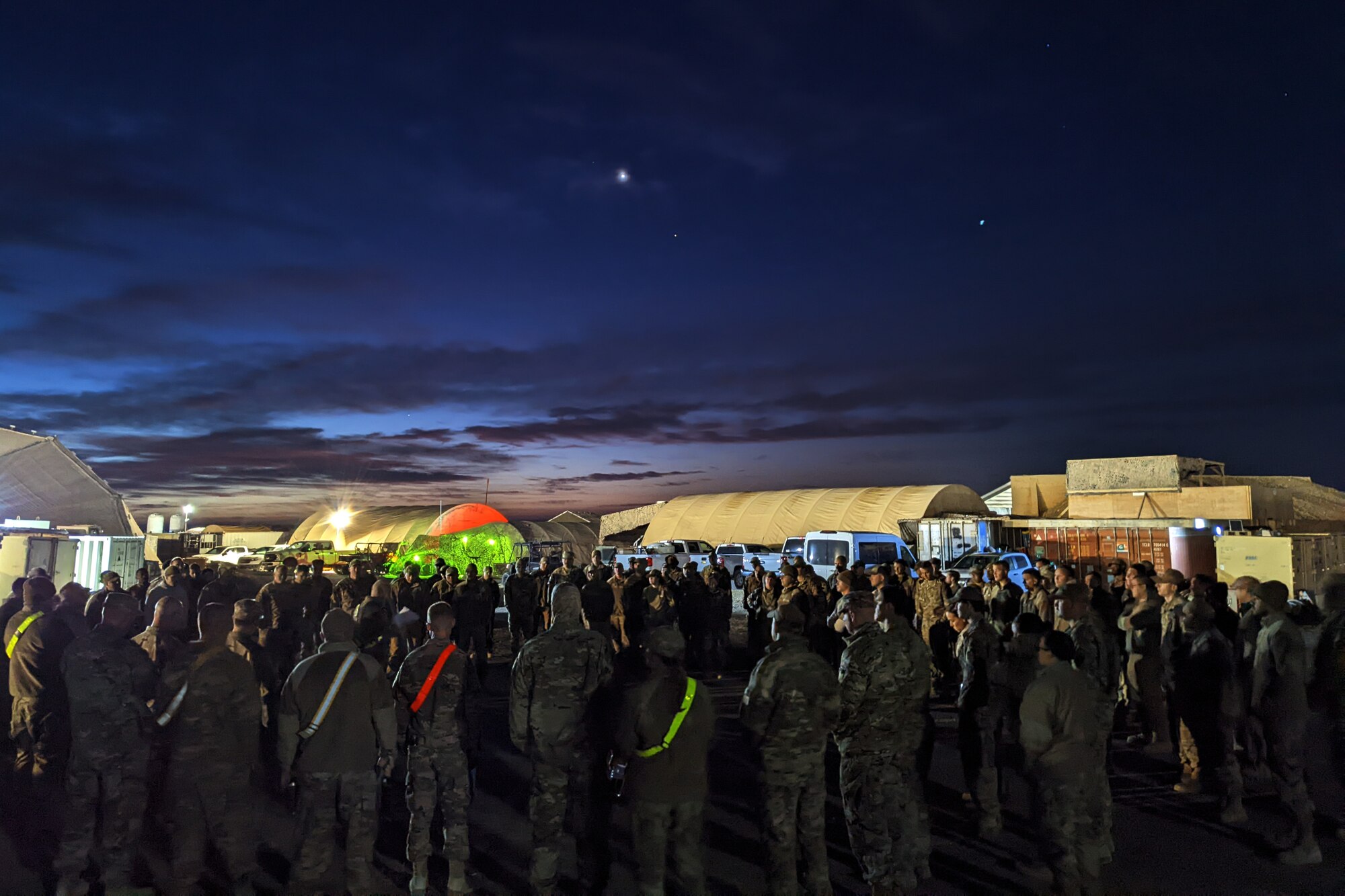 332d Expeditionary Civil Engineer Squadron Airmen receive a briefing for the Rapid Airfield Damage Recovery (RADR) exercise an undisclosed location in Southwest Asia, Feb. 10, 2022. This exercise tested the ability of the 332d ECES to rapidly repair runways and runway support structures to recover and resume airfield operations after it has experienced significant damage. The 332d ECES provides, operates, and maintains a sustainable installation through engineering and emergency response services across the full mission spectrum. (U.S Air Force photo by Tech. Sgt. Lauren M. Snyder)
