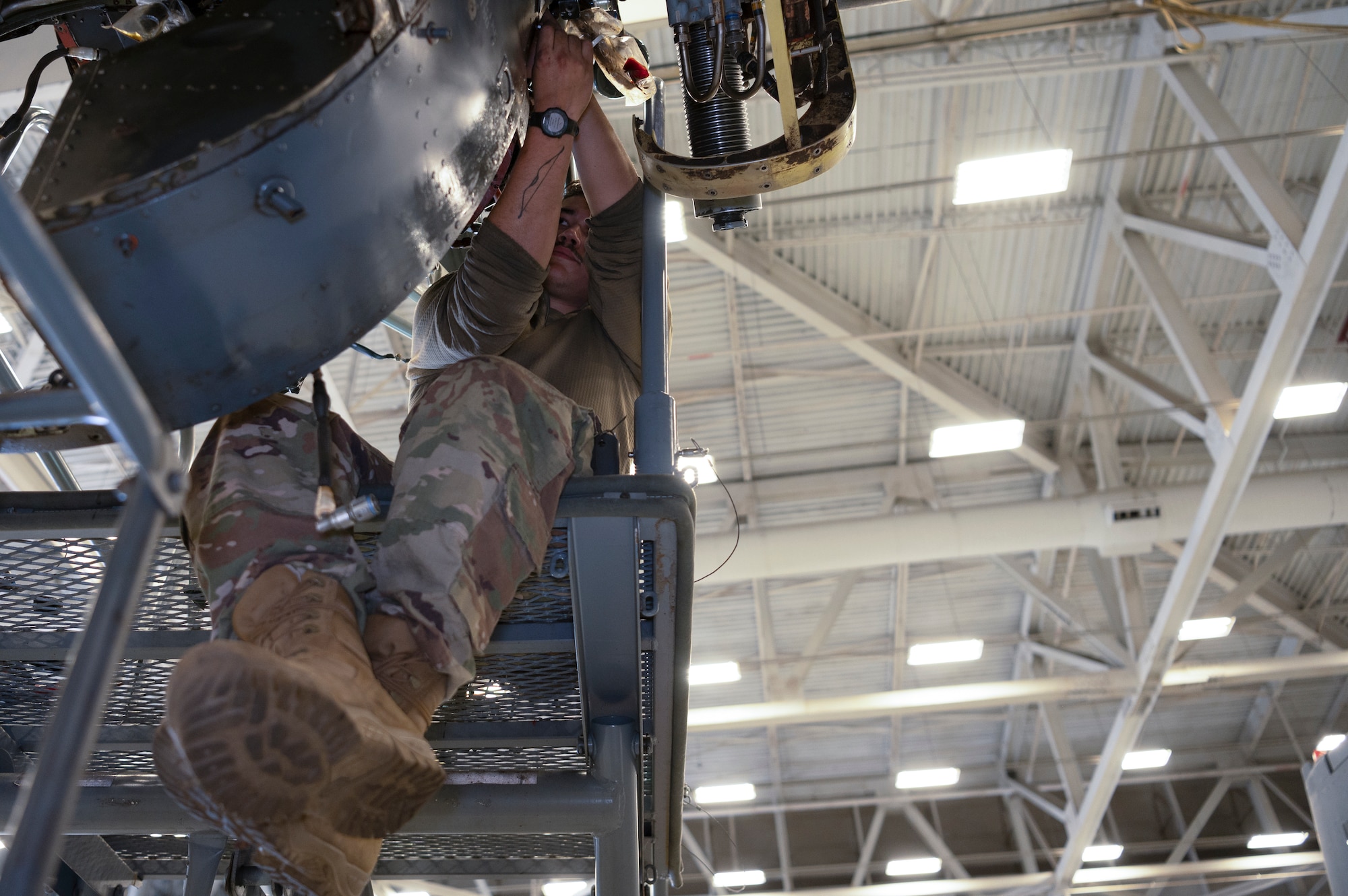 Senior Airman Thomas Perez, an 801st Special Operations Aircraft Maintenance Squadron CV-22 Osprey crew chief, installs an inboard proprotor gearbox horizontal fire baffle during maintenance at Independence Hangar on Hurlburt Field, Fla., Feb15, 2022. The mission of the CV-22 is to conduct long-range infiltration, exfiltration, and resupply missions for special operations forces.