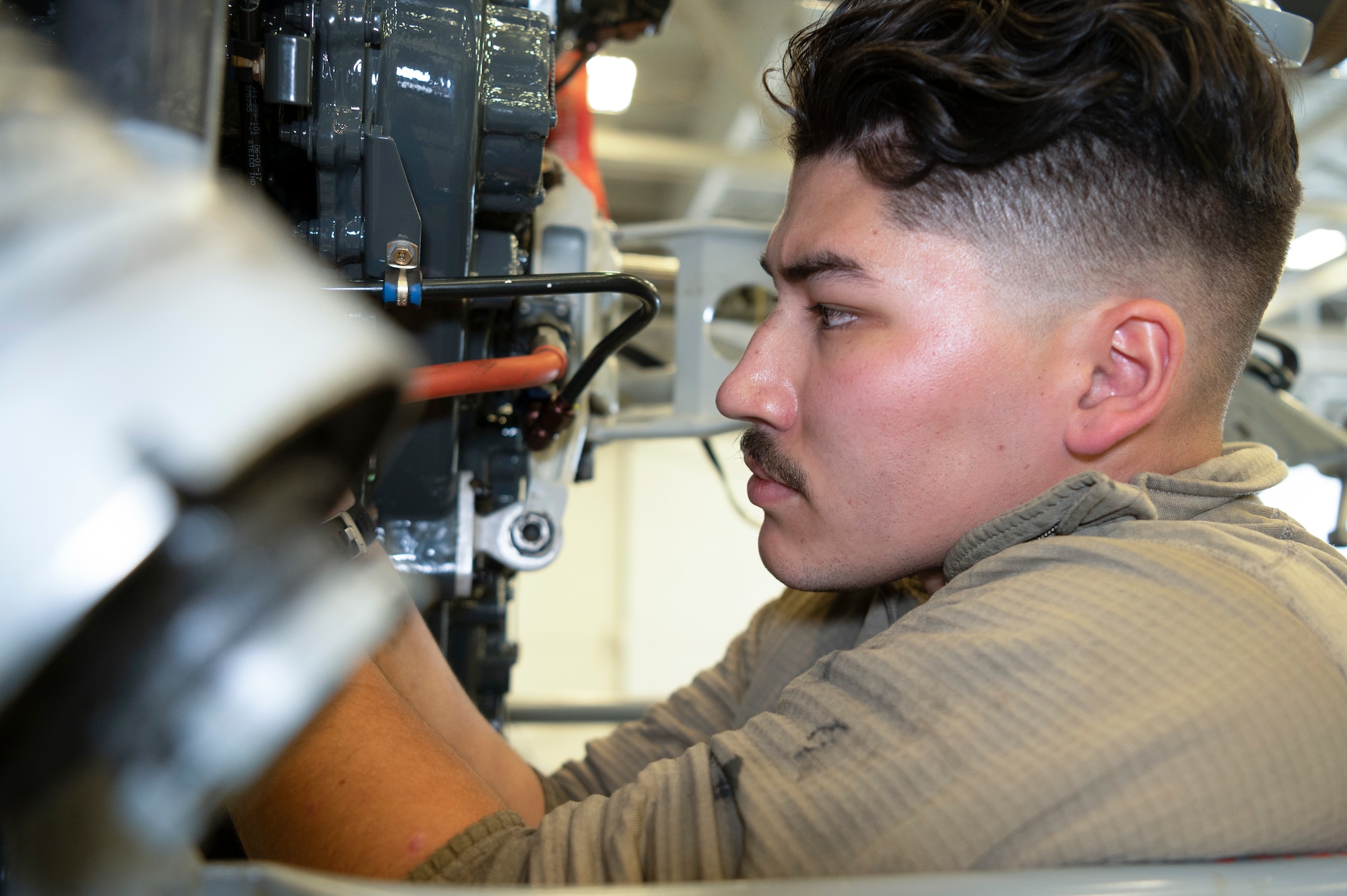 Senior Airman Thomas Perez, an 801st Special Operations Aircraft Maintenance Squadron CV-22 Osprey crew chief, uses a socket wrench to secure a bolt during maintenance at Independence Hangar on Hurlburt Field, Fla., Feb15, 2022. The mission of the CV-22 is to conduct long-range infiltration, exfiltration, and resupply missions for special operations forces.