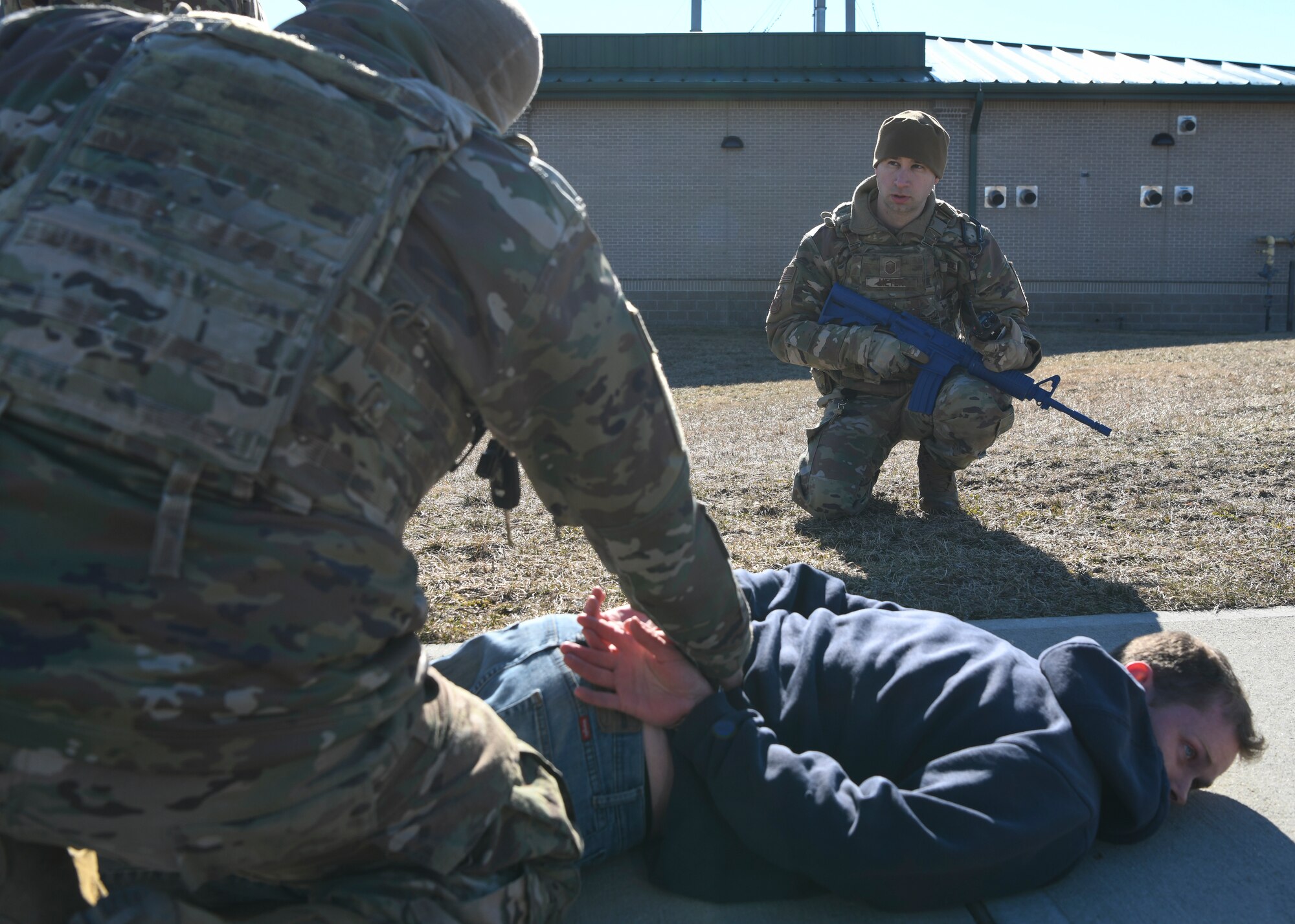 Members of the 106th Security Forces Squadron participate in an installation breach training exercise at NY Air National Guard’s 106th Rescue Wing, Francis S. Gabreski Air National Guard Base, Westhampton Beach, N.Y., March 4, 2022. During the training, the suspect being detained failed to stop at the base entrance and was subsequently arrested by 106th Security Forces. (U.S. Air National Guard photo by Staff Sgt. Daniel H. Farrell)