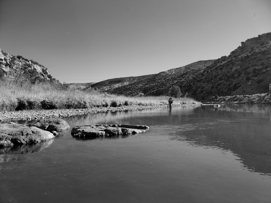 ABIQUIU LAKE, N.M. -- A man fishes on the Rio Chama, downstream of Abiquiu Dam, Jan. 29, 2022. Photo by Michael Kohler.