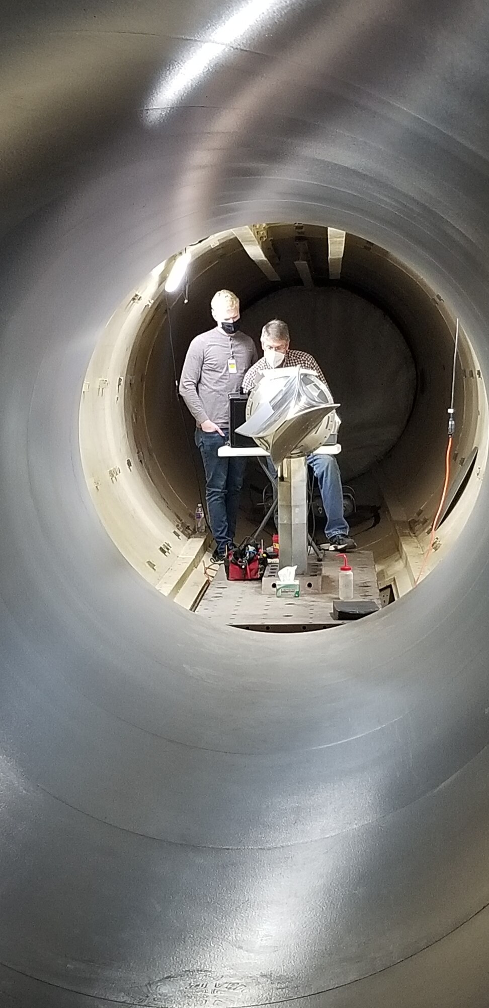 Josh Day and Dave Adamczak of AFRL's Aerospace Systems Directorate by BOLT II, installed in the CUBRC LENS II wind tunnel for the first-ever pre-test of a flight vehicle in the expected flight conditions. (Courtesy photo)