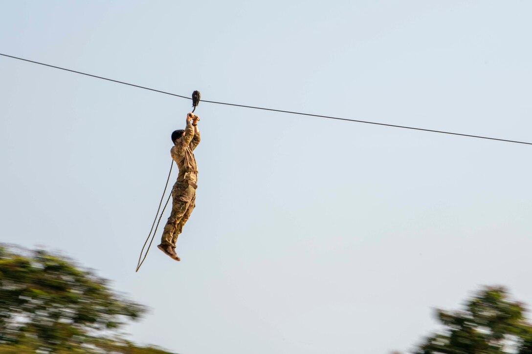 A soldier zip lines during training.