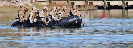 Cavalry Soldiers splash through water operations training
