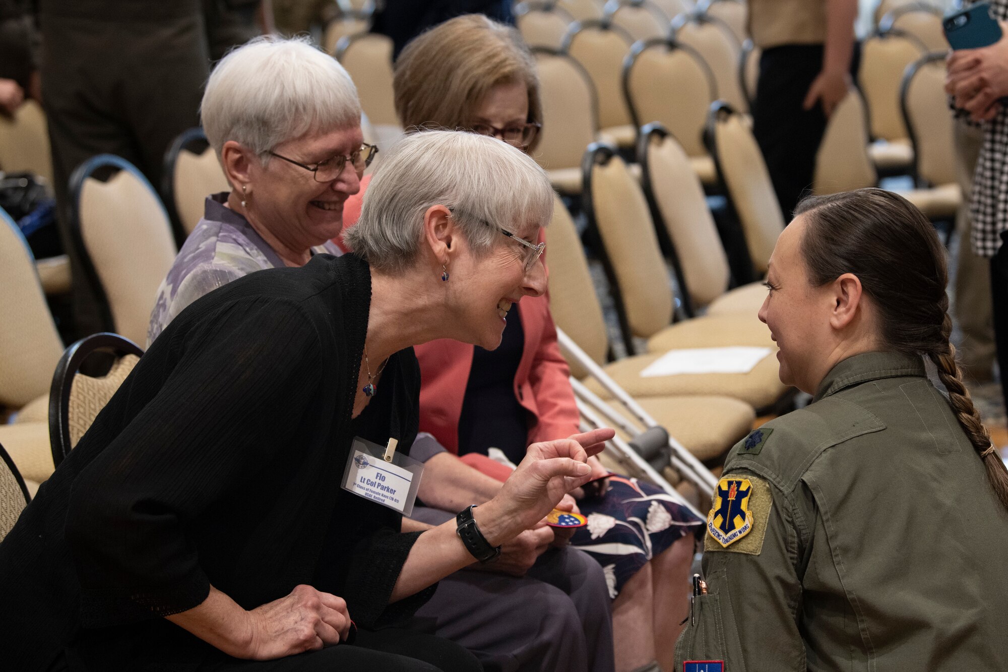 Lt. Col. (Ret.) Florence Parker speaks with an attendee during the Undergraduate Combat Systems Officer Training (UCT) Sapphire Event March 11, 2022, at Naval Air Station Pensacola, Florida