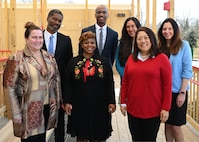 (Front) Teresa Quinn-Veseley, 11th Force Support Squadron; Shanee Johnson, Apple Tree at LEARN DC principal; Cherise Imai, executive director of the Military Interstate Children's Compact Commission; and (Back row) Horace Franklin, Naval District Washington school liaison; Alonso Hay, Joint Base Anacostia-Bolling school liaison; Andrea Groeninger, LEARN DC principal; and Commissioner Clara Botstein, director of legislation and government relations at the D.C. office of the deputy mayor for education, pose for a group photo on March 15, 2022 on the campus of the first charter school on JBAB, Washington, D.C. Botstein and Imai toured JBAB, Washington, D.C. and met members of the 11th Force Support Squadron and the LEARN DC team in order to gain a deeper understanding of the concerted interagency effort that made the school possible, as well as to learn about the diverse mission partners that operate on the installation. (U.S. Air Force photo by Staff Sgt. Kayla White)