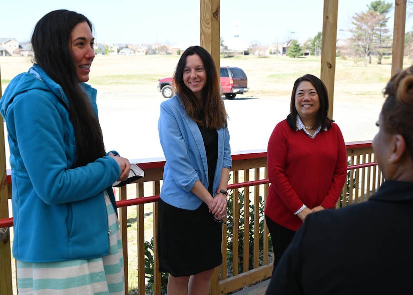 Cherise Imai, executive director of the Military Interstate Children's Compact Commission; and Commissioner Clara Botstein, director of legislation and government relations at the D.C. office of the deputy mayor for education, listen to Andrea Groeninger, LEARN DC principal, speak during an engagement at the charter school's campus on Joint Base Anacostia-Bolling, Washington, D.C. on March 15, 2022. Botstein and Imai toured JBAB, Washington, D.C. and met members of the 11th Force Support Squadron and the LEARN DC team in order to gain a deeper understanding of the concerted interagency effort that made the school possible, as well as to learn about the diverse mission partners that operate on the installation. (U.S. Air Force photo by Staff Sgt. Kayla White)