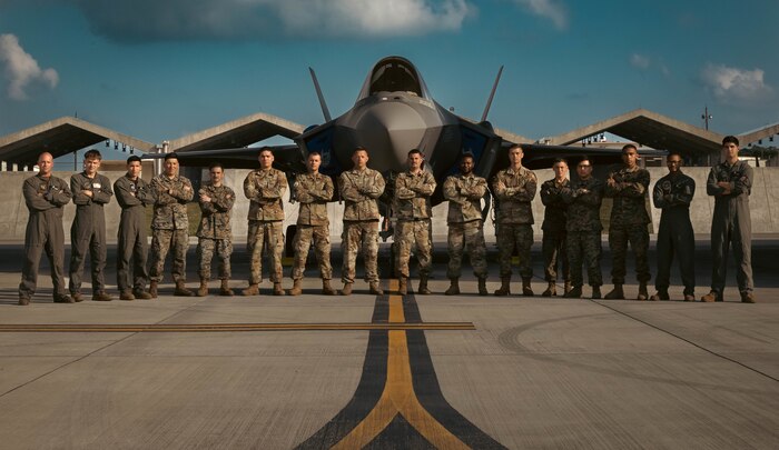 U.S. Marines, with Marine Corps Installations Pacific, and Airmen with the 355th Expeditionary Fighter Squadron pose for a photo during a hot-pit refueling training no Kadena Air Base, March 9, 2022. The training refined and enhanced the multiple aircraft platform skills of participating Marines, focusing on hot-pit refueling the F-35A Lightning II with limited time, simulating an operational environment. During hot-pit refueling, the aircraft maintains a running engine, which decreases the response time in an operational environment.