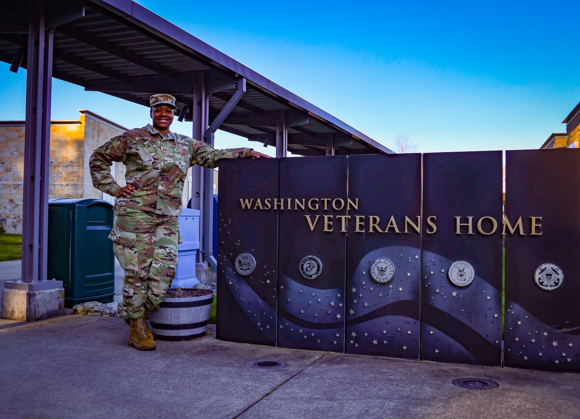 Air Force Capt. Geneva Hoskins-Dorsey, 194th Medical Group, Washington Air National Guard, poses for a photo at the Veterans Home in Port Orchard, Washington, March 9, 2022. Hoskins-Dorsey was the officer in charge of the Port Orchard facility as members of her team helped veterans' home employees by answering resident call lights and non-clinical requests and performing COVID screenings.