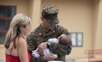 Service member holds newborn child